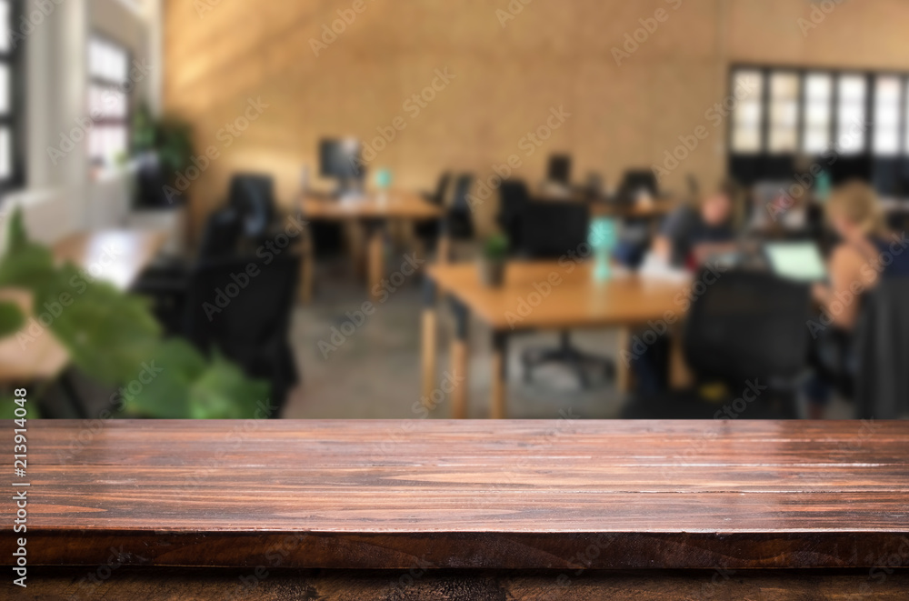 Selected focus empty brown wooden table in office with big windows of the Background with bokeh image. for your photomontage or product display Selected focus empty brown wooden table in office with big windows of the Background with bokeh image. for your photomontage or product display