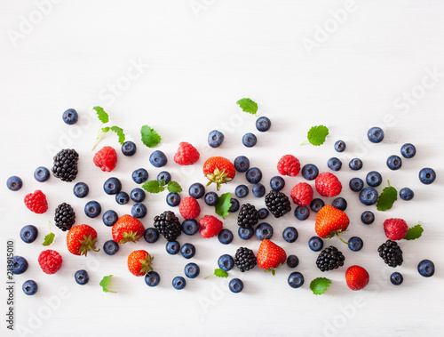 assorted berries over white background. blueberry, strawberry, raspberry, blackberry