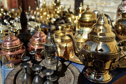 Ancient East dishes. Teapots, cups, lamps, jugs, made of gold, brass, handmade silver. A shopkeeper's shop. Uzbek Oriental Traditions. Bukhara
