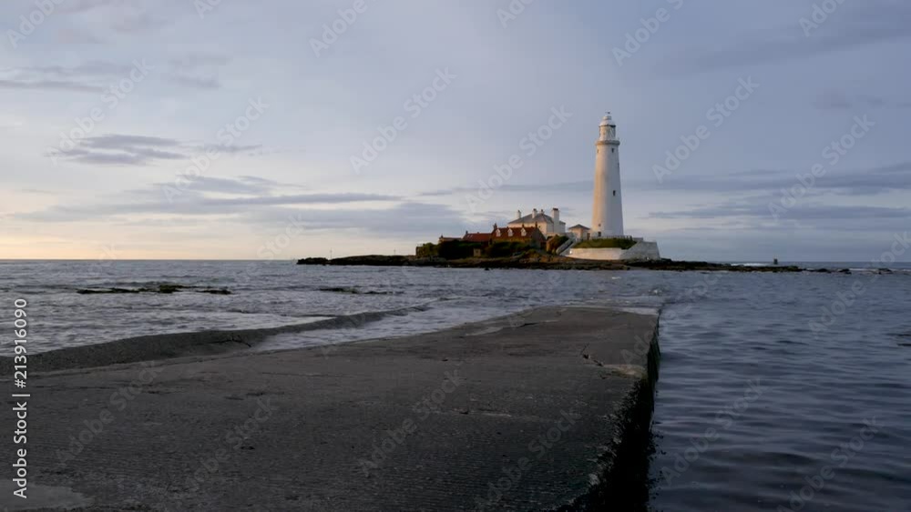 The incoming tide covers the causeway at St Mary's Lighthouse during golden hour. Shot wide and low. The incoming tide covers the causeway at St Mary's Lighthouse during golden hour. Shot wide and low.