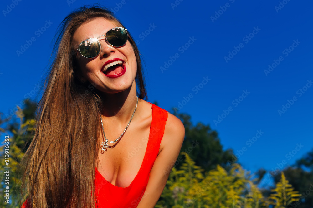 beautiful smile girl in sunglasses on the background of nature on a beautiful sunny day beautiful smile girl in sunglasses on the background of nature on a beautiful sunny day