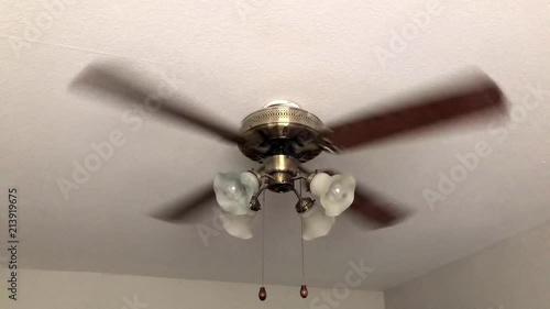 Full shot of a 4 blade ceiling fan. photo