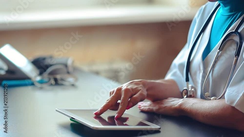 Woman doctor using tablet computer in hospital