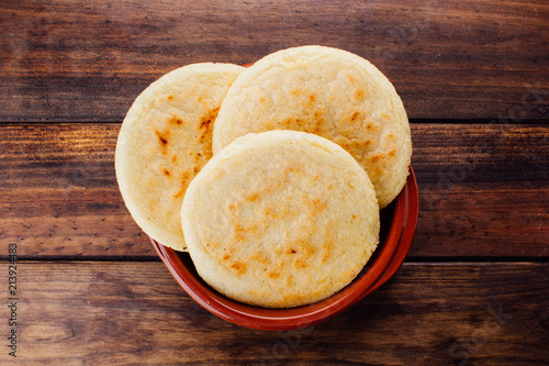 Plate with arepas on a rustic wooden background