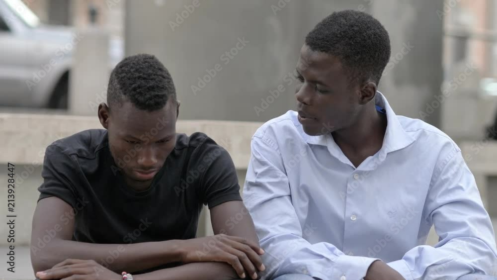 friendship, complicity, support. African man comforting his sad friend friendship, complicity, support. African man comforting his sad friend