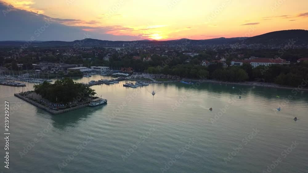 Balatonfured, Hungary - 4K drone flying above leaving sail boat at yacht marina of Balatonfured at sunset Balatonfured, Hungary - 4K drone flying above leaving sail boat at yacht marina of Balatonfured at sunset