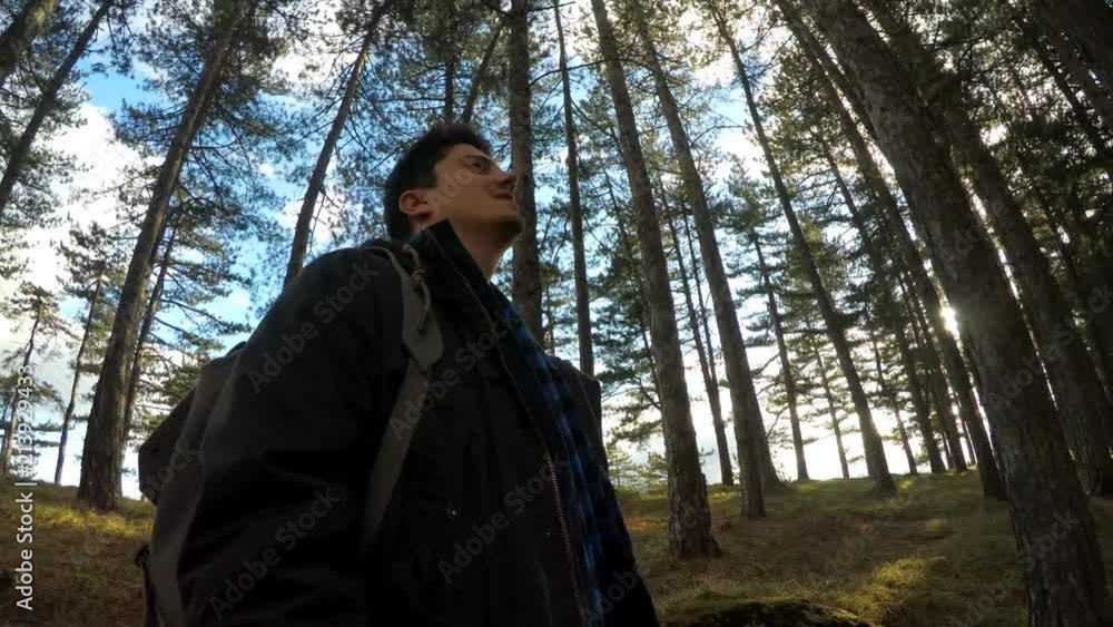 young man standing in forest young man standing in forest