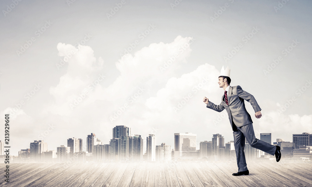 King businessman in elegant suit running and modern cityscape at King businessman in elegant suit running and modern cityscape at