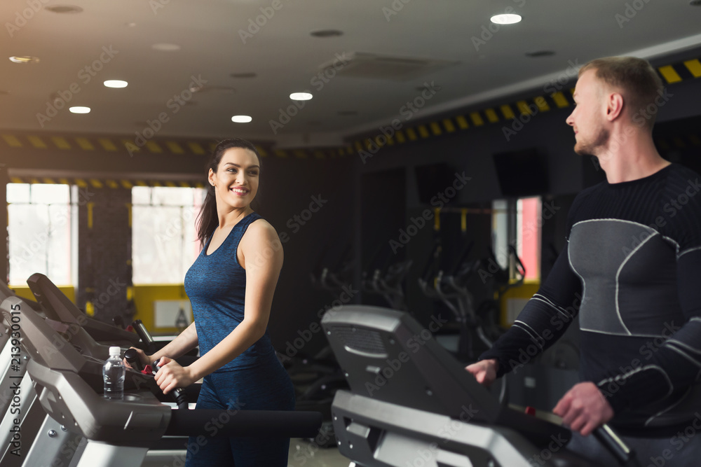 Fitness people training in gym on treadmills Fitness people training in gym on treadmills