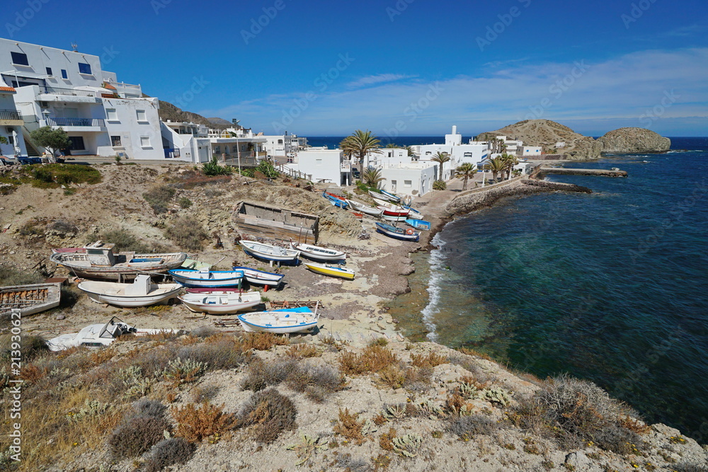 Typical fishing village La Isleta del Moro with small boats on the shore of the Mediterranean sea, Cabo de Gata-Níjar natural park, Almeria, Andalusia, Spain