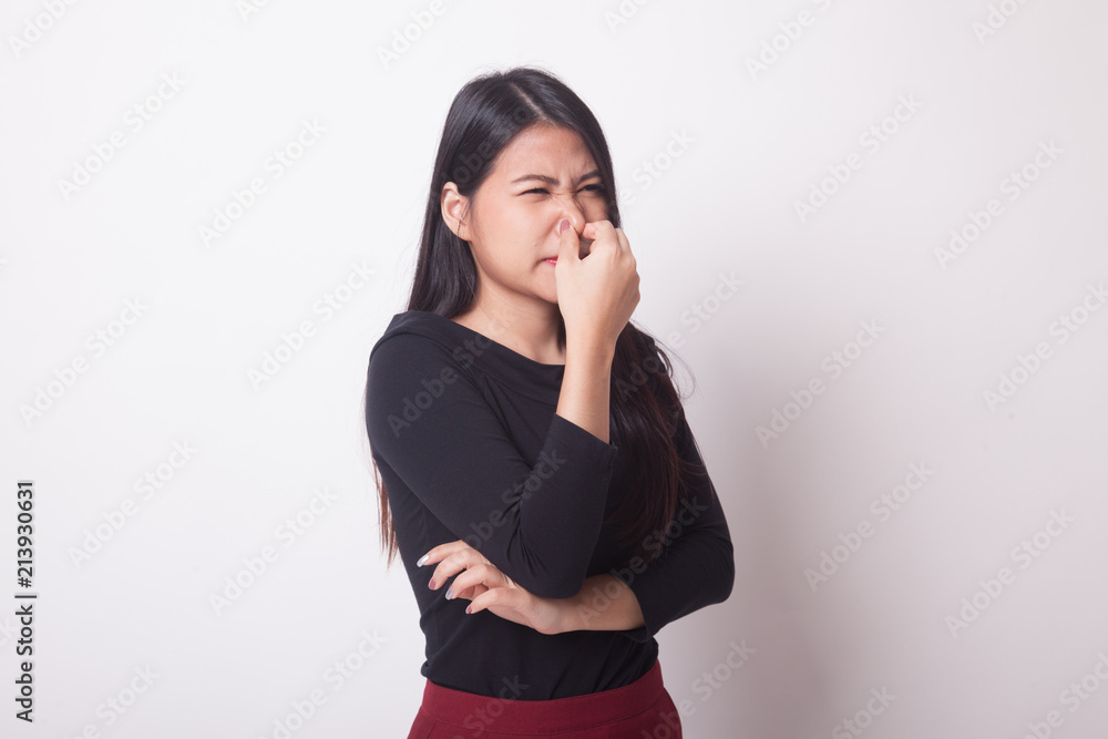 Young Asian woman holding her nose because of a bad smell. Young Asian woman holding her nose because of a bad smell.