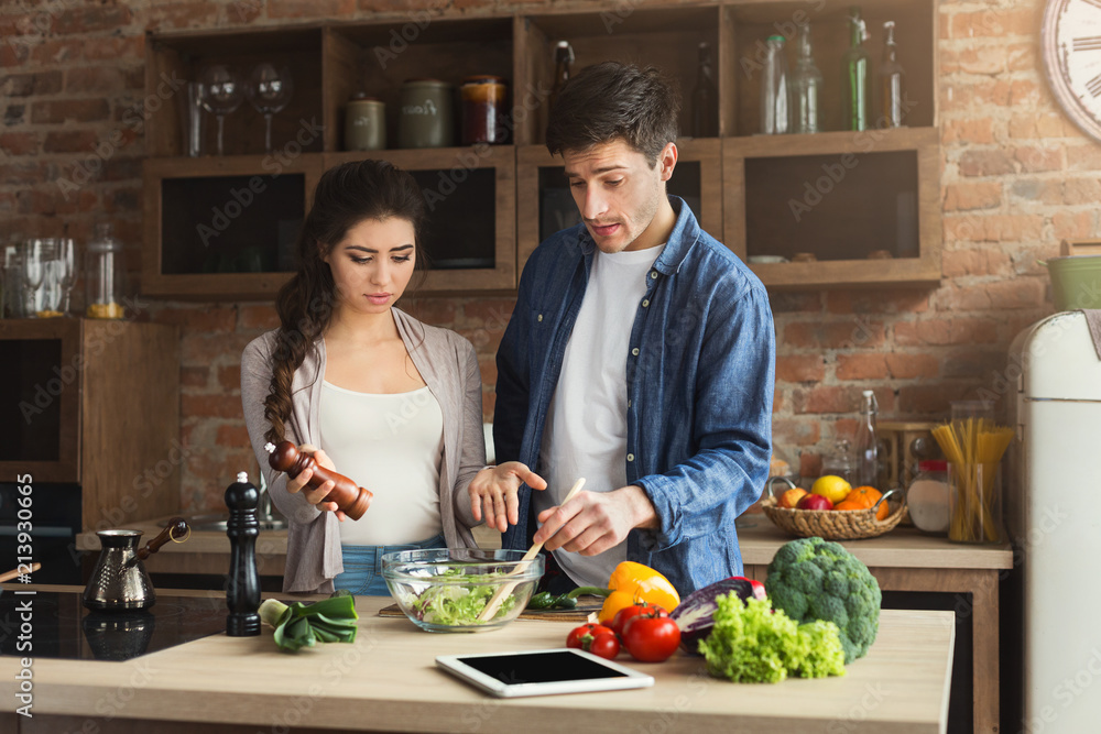 Young couple cooking healthy food together