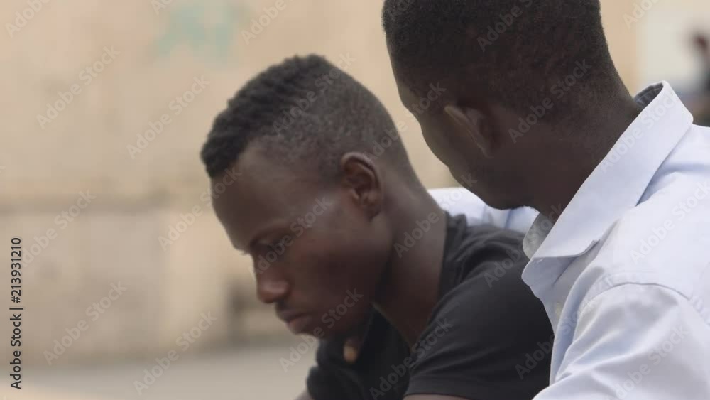 friendship, comfort, affection. young black man comforting his depressed friend friendship, comfort, affection. young black man comforting his depressed friend