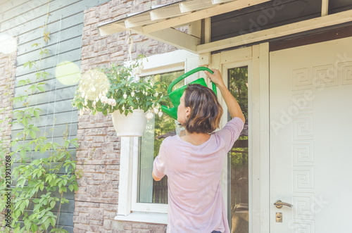 the flowers girl near flowers on a Sunny summer day