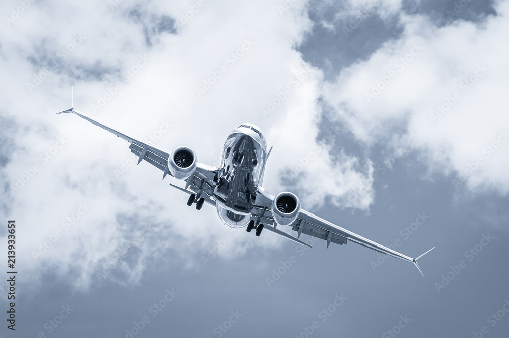 blue toned passenger jet cross-wind landing