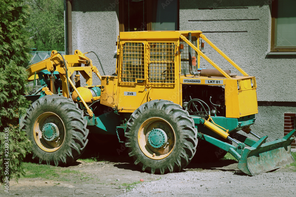 A small yellow tractor for many works