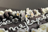 A part of chocolate cake with inscription Vše nejlepší as part of birthday gift