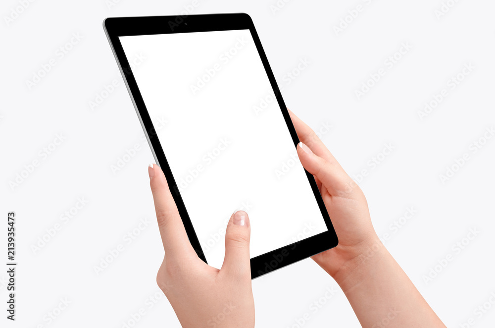 Female hands holding black tablet in vertical position isolated on white background. Empty screen for mockup design