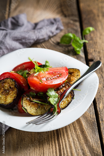 Salad of baked eggplants and fresh tomatoes with parsley