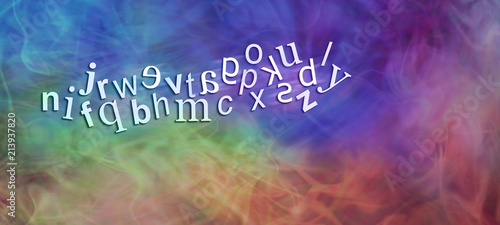 Chaotic Dyslexic Alphabet with reversed letters - wide rainbow coloured banner with a jumbled complete alphabet showing six moving characters reversed depicting dyslexia with plenty of copy space 
 photo