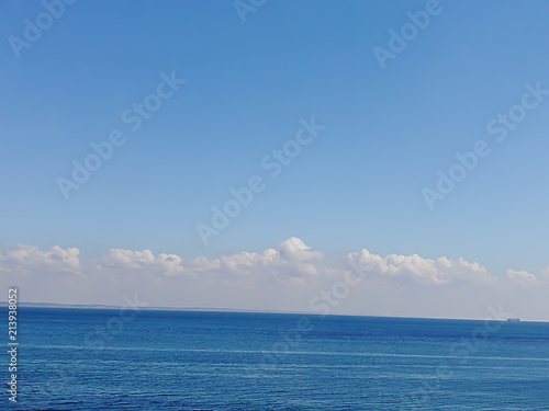 background of beautiful blue black sea under fluffy white clouds under the blue sky