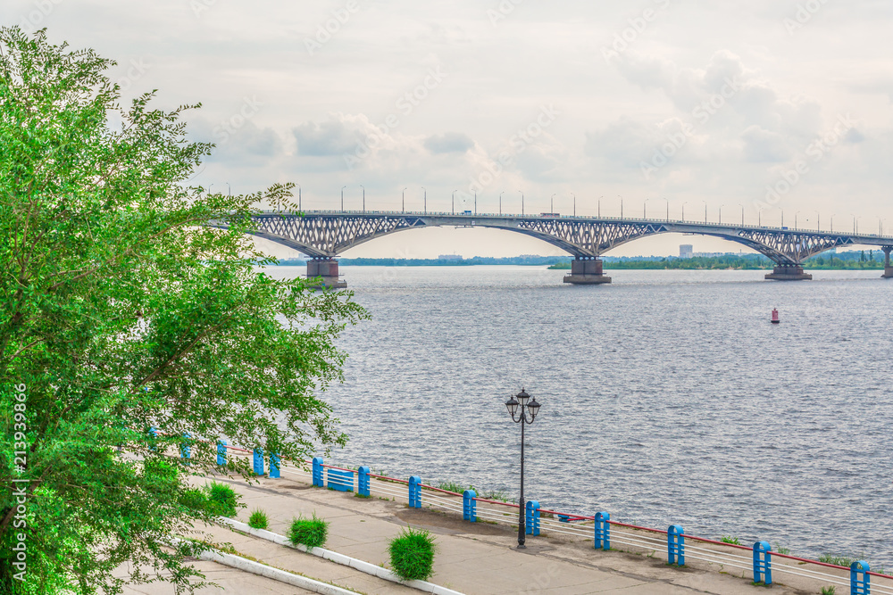Road bridge over the Volga river between Saratov and Engels, Russia. Cloudy summer day. City quay.