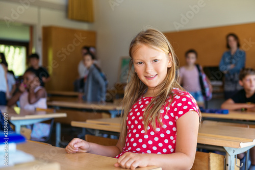 Indoor portrait of a cute little girl in a classroom