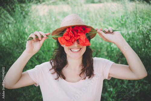 Woman holding a bouquet of red poppies in spring