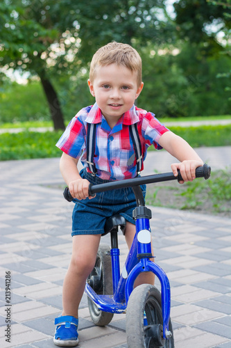 Little boy riding a bike ride in the park