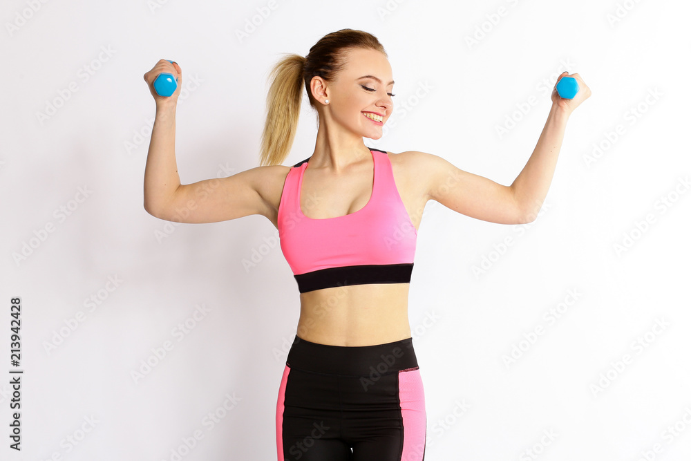 Young girl athlete, fitness with dumbbells isolated on white background Young girl athlete, fitness with dumbbells isolated on white background