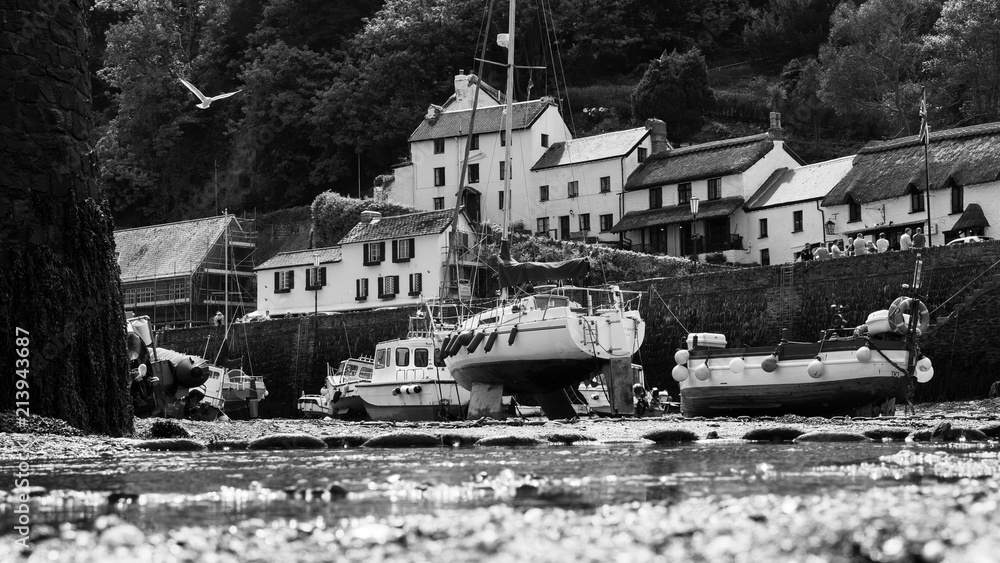 Boats moored in Lynmouth harbor at low tide