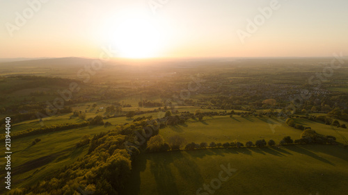 Aerial of golden sunset in Cotswold landscape scenery in England photo