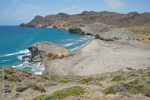 Sandy beach and rock formation on the sea shore, Playa de Mónsul in the Cabo de Gata-Níjar natural park, Mediterranean sea, Almeria, Andalusia, Spain