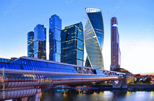 Moscow Russia, modern abstract architecture and scyscrapers with bridge on river against  blue  sky in modern businees district photo