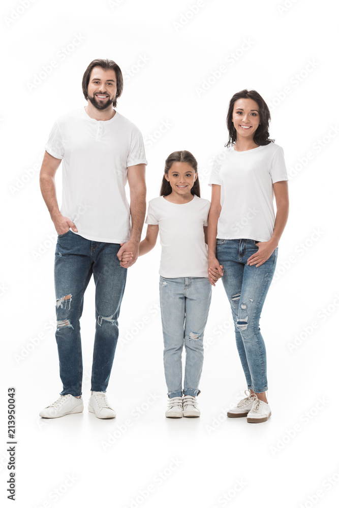 smiling family in white shirts holding hands and looking at camera isolated on white smiling family in white shirts holding hands and looking at camera isolated on white