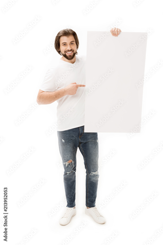 smiling bearded man pointing at blank banner in hand isolated on white