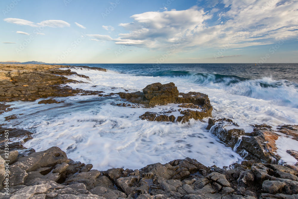 Sunset seascape scene. Waves crushing over rocks. Beautiful warm and soft light. Quiet, relaxing. Wind, breeze. Travel, holidays, sport, wander. Sunset seascape scene. Waves crushing over rocks. Beautiful warm and soft light. Quiet, relaxing. Wind, breeze. Travel, holidays, sport, wander.