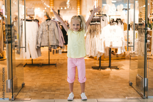 selective focus of happy little child standing with wide arms in shop © LIGHTFIELD STUDIOS