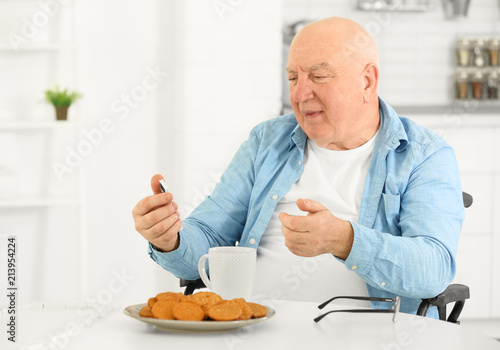 Senior man having breakfast...