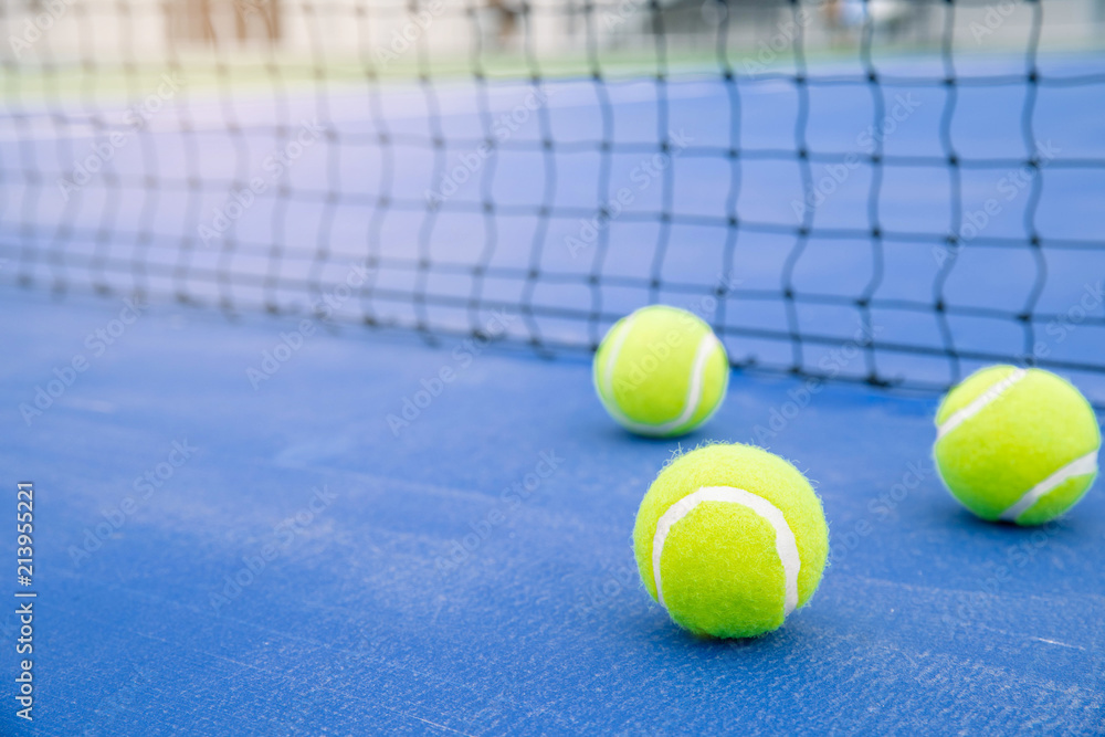 Tennis ball on a tennis court. Close up of tennis ball on hard court.