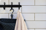 Clean Colored towels hanging on the rack in the bathroom. Focus on the top of the hook and towels