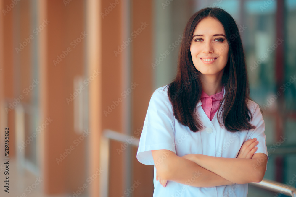 Smiling Female Doctor in Uniform in Front of Hospital Clinic Smiling Female Doctor in Uniform in Front of Hospital Clinic
