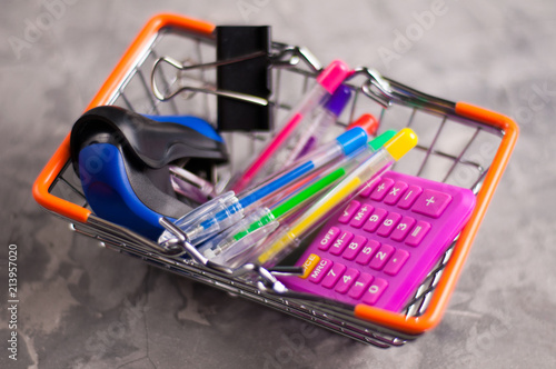 Wallpaper Mural Full metal market basket of school supplies on gray concrete background. Education or business concept Torontodigital.ca