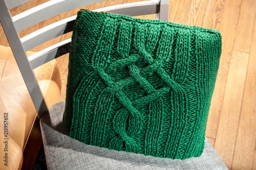 knitted cushion lying on the chair, to improve orthopedics back of the chair