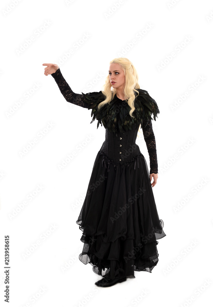 full length portrait of blonde girl wearing corset and long black gown. isolated on white studio background, full length portrait of blonde girl wearing corset and long black gown. isolated on white studio background,