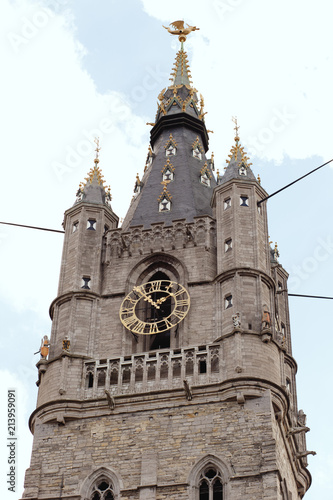 The medieval belfry of Ghent is visible to the street in front of the Botermarkt , Belgium photo