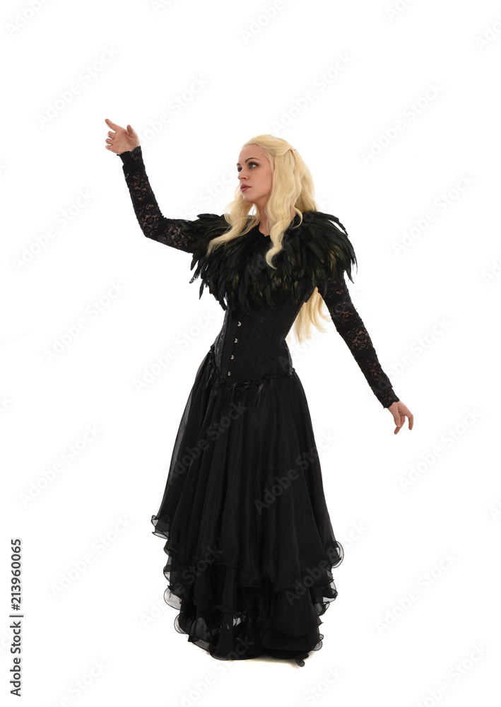 full length portrait of blonde girl wearing corset and long black gown. isolated on white studio background, full length portrait of blonde girl wearing corset and long black gown. isolated on white studio background,