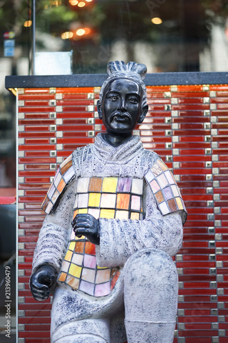 Canvas Print A statue of a Chinese soldier wearing a colorful suit of armor with selective focus on the eyes