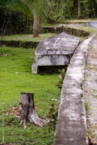 Old fishing boat on green grass of Golfito, Costa Rica.  Day to day life in the small village of Golfito, Costa Rica. photo