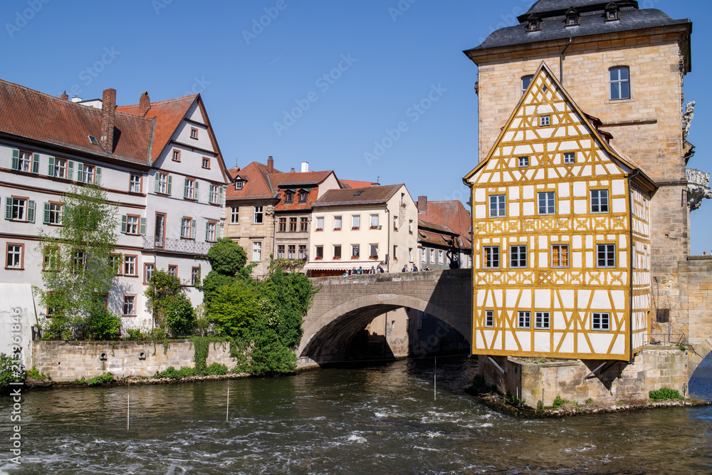 Bamberg. Panoramic view of Old Town Hall of Bamberg (Altes Rathaus) with two bridges over the Regnitz river, Bavaria, Germany
